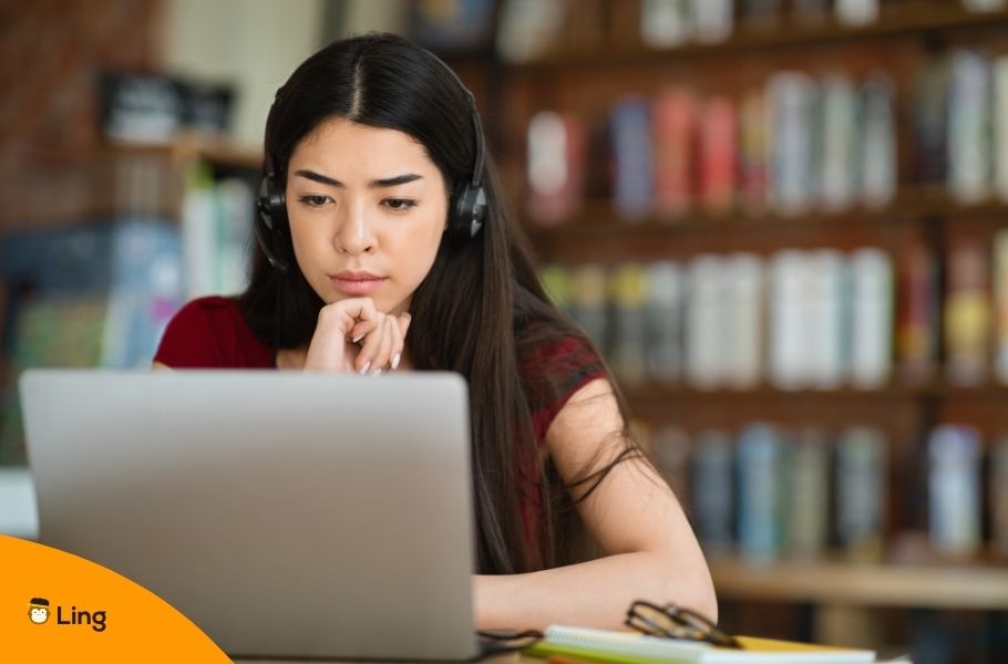 Young Woman Studying With A Laptop In A Library