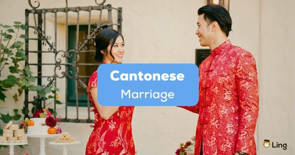 A photo of a newly wed Asian couple wearing their traditional red clothes behind the Cantonese Marriage texts.