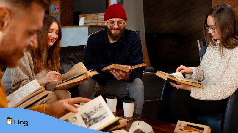 A photo of a group of people sitting while reading books about the Estonian culture.