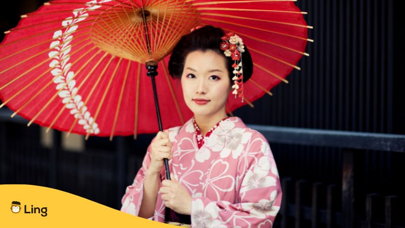 Japanese woman dressed with Kimono and holding an umbrella 