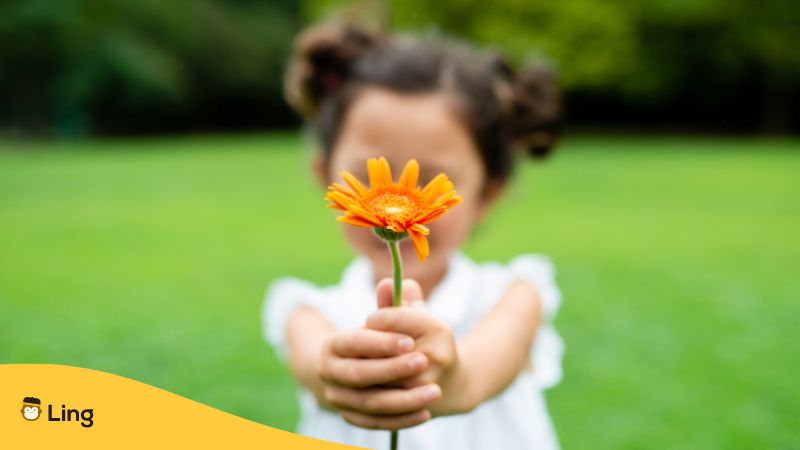 Polite-Malayalam-Phrases-ling-app-child-holding-a-flower
