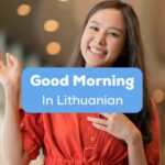 A photo of a pretty smiling girl waving her hands behind the Good Morning In Lithuanian texts.