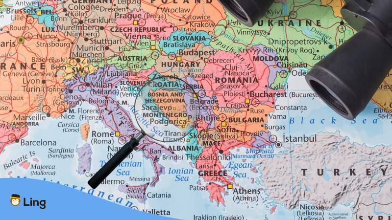 A photo of a map with the magnifying glass on Herzegovina Bosnia area.