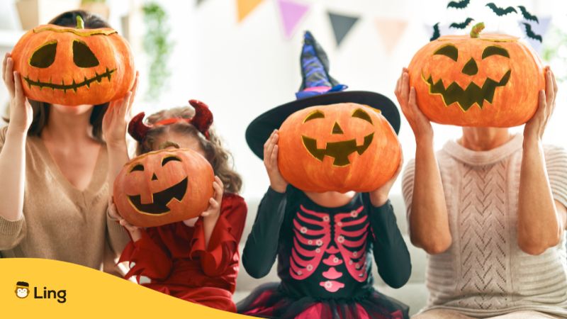 children and adults wearing halloween costumes and pumpkin masks