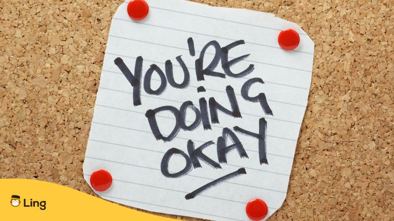 you're doing okay written on paper and posted on cork board wall