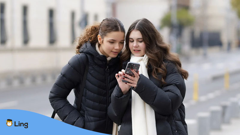 Two girls looking at a smartphone
