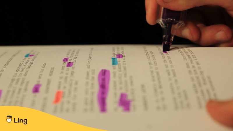 a hand highlighting parts of a film script