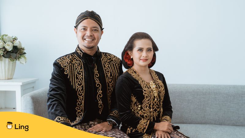Laotian man and woman sitting while wearing Lao traditional dress and outfit