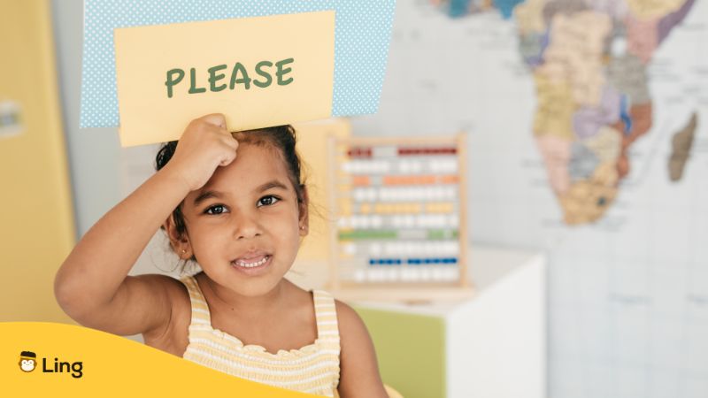 a child holding a please sign on her forehead