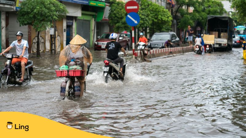 flooded road in Vietnam with motorists