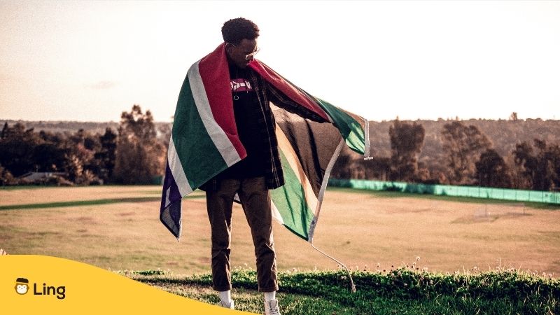 South African man holding a flag from South Africa