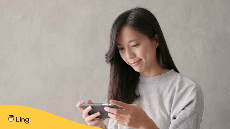 A Photo Of A Woman Learning Indonesian On An App