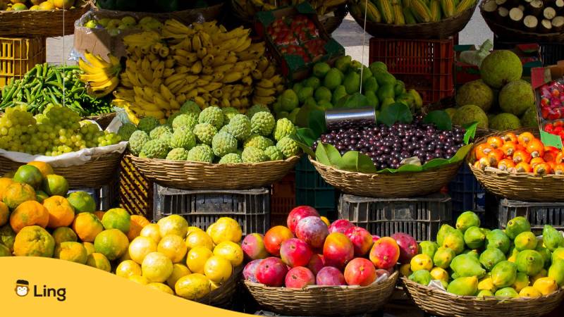 Slowakischer Marktstand mit Körben unterschiedlicher Obst und Früchtesorten. Lerne mit der Ling-App, was Gemüse auf Slowakisch bedeutet. 