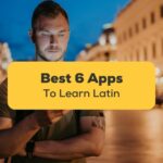 apps to learn Latin - A photo of a man using his phone while standing in the middle of the street