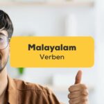 Glücklicher indischer Mann, Malayalamlehrer, macht den Daumen hoch. Lerne Malayalam Verben mit der Ling-App.