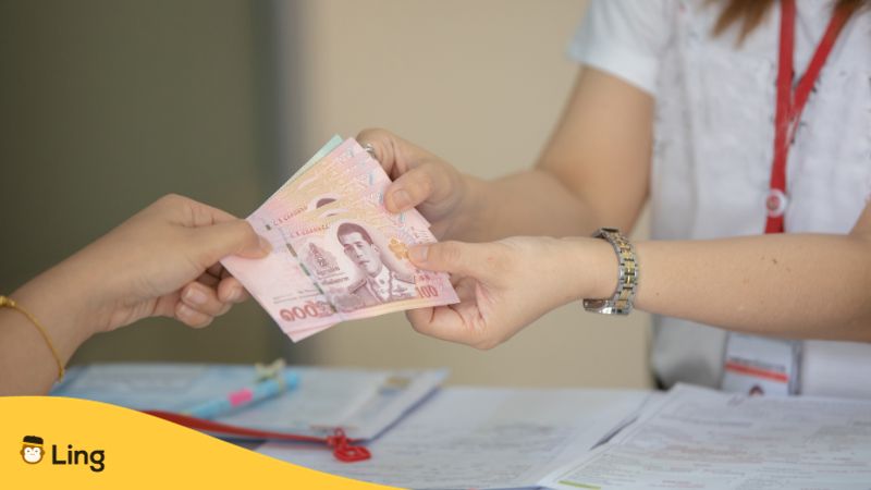 nombres en thaï
billets de banque thaïlandais tenus par deux personnes avec mains