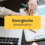 Georgisch lernende macht Notizen und arbeitet am Laptop. Lerne georgische Satzstruktur mit der Ling-App.
