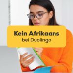 Junge Frau lernt die Afrikaans-Sprache online von zu Hause aus. Südafrika Flagge aus Seide.