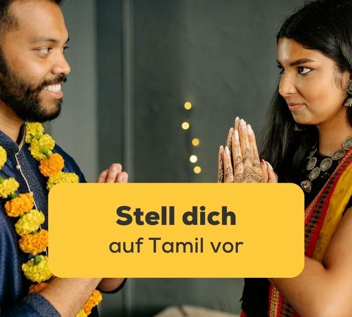 Ein Mann und eine Frau, die ihre Hände zusammenhalten, um sich vorzustellen. Stell dich auf Tamil vor auf die richtige Art und knüpfe Kontakte!