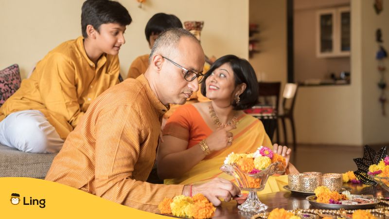 A photo of a Hindi family wearing yellow clothes celebrating Vasant Panchami
