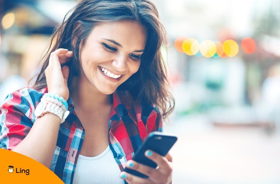 Woman Smiling Reading A Text Message