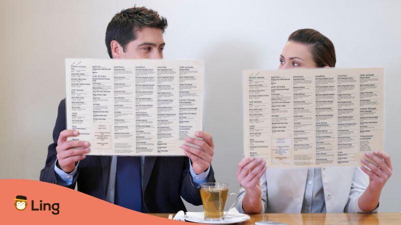 a man and a woman reading a restaurant menu to make an order in - ordering food in turkish