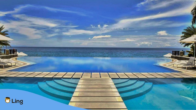 romantic getaways near manila for couples - A photo of Acuatico Beach Resort infinity pool.