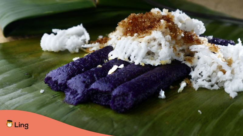 A photo of a puto bumbong served on a banana leaf.
