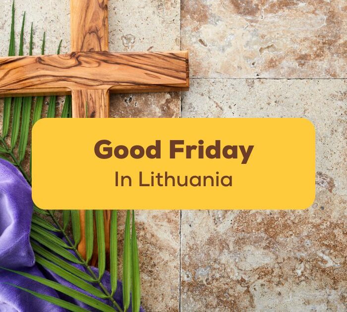 Wooden cross in the background of a written text with Good Friday in Lithuania