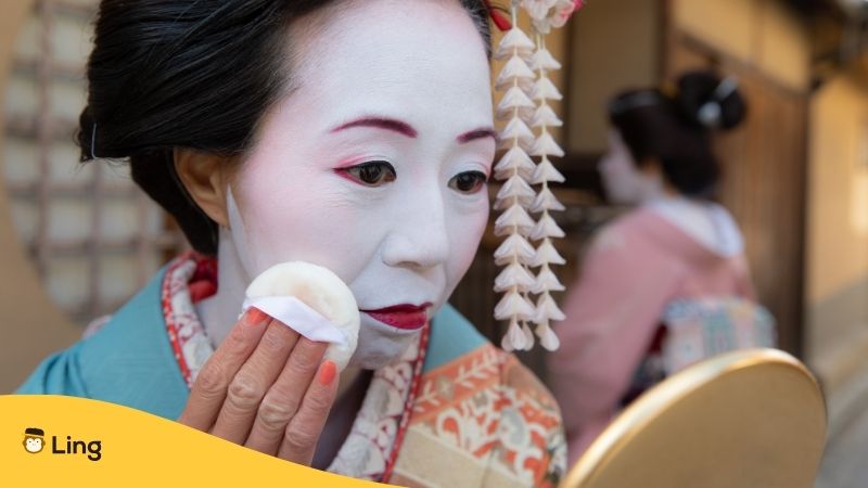A geisha preparing for the Kitano Odori in Japan