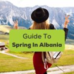 Spring in Albania - A back photo of a female traveler looking at mountains.
