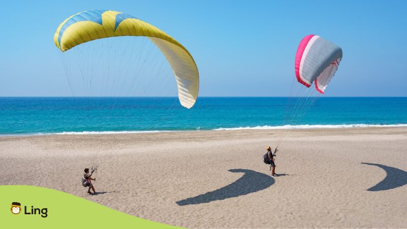 What to do in Albania - two paragliders at the beach.