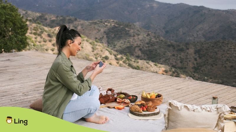 Spring i nAlbania - A photo of a woman with foods and a panoramic view of mountains.
