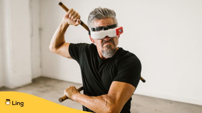 A blindfolded man performing Arnis with a stick