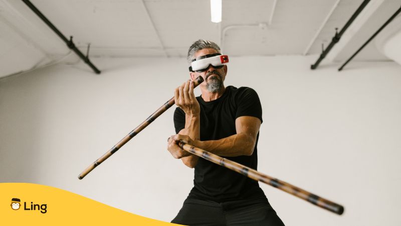 A blindfolded man performing Arnis with two sticks