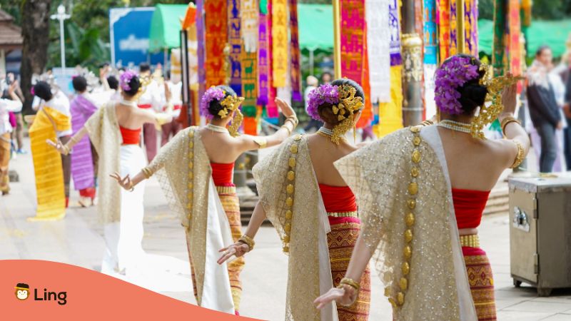 women dressed in Thai costumes doing Thai dance in wan lai festival