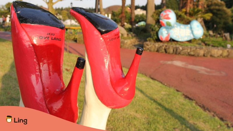 A photo of a woman's red shoes in Jeju Island's Loveland.