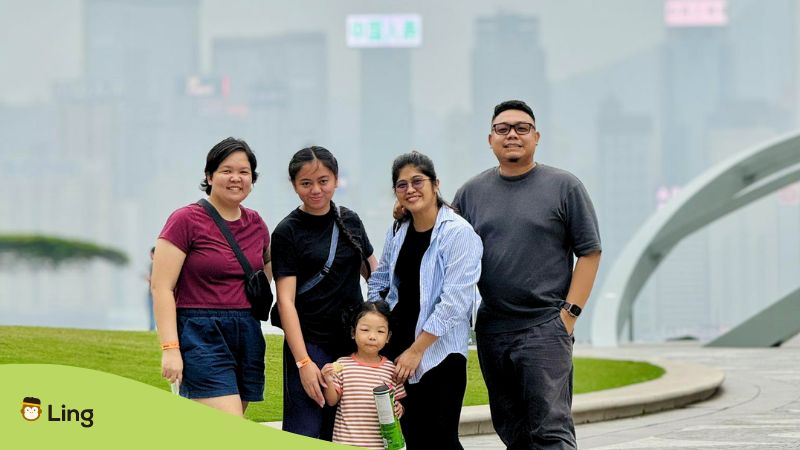 A photo of a family traveling in Hong Kong during foggy weather.