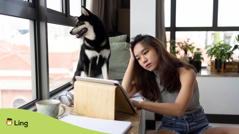 Weird Japanese words - A photo of an unhappy woman with her dog in the background.