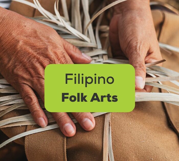 Hands weaving Filipino folk arts using natural fibers called abaca.