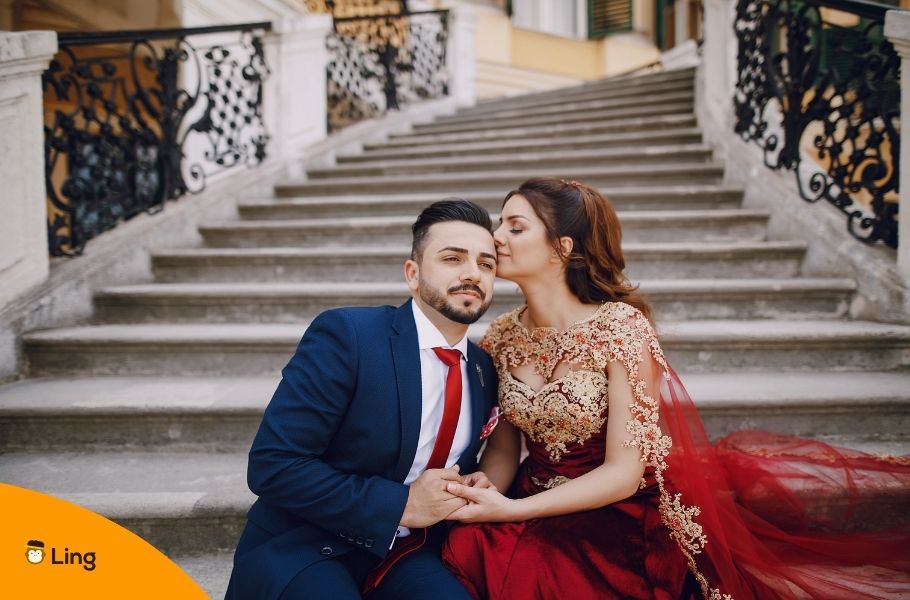 Well-Dressed Turkish Couple Sitting In A Stairwell