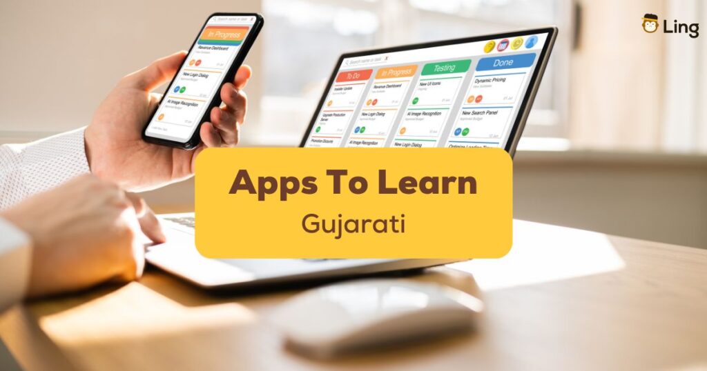 Close-up of hands using a phone and a computer - Apps to learn Gujarati