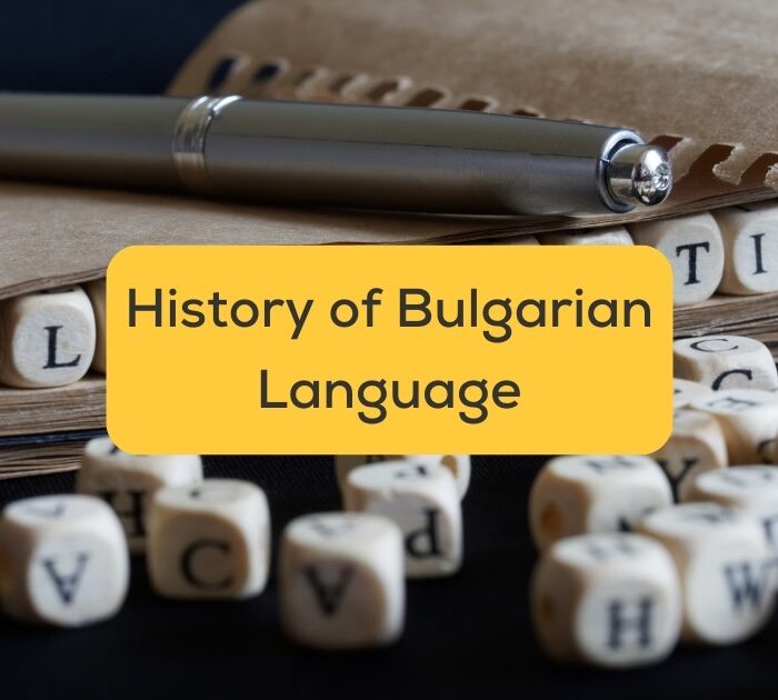 Notebook, pen, and small wooden blocks with letters - History of Bulgarian language