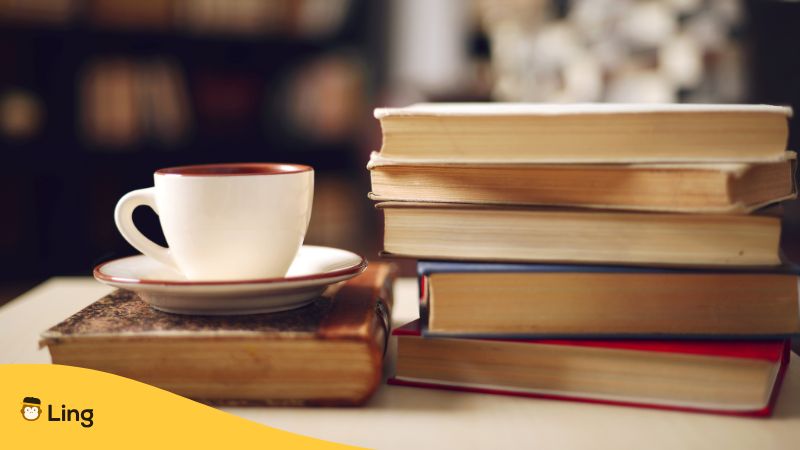 A cup and a stack of books