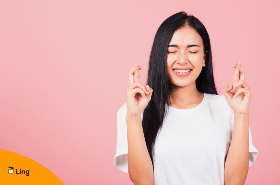 Smiling Woman With Her Fingers Crossed