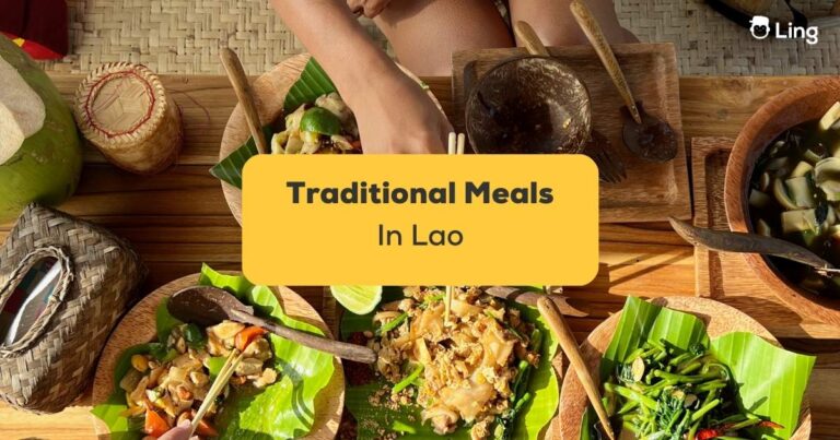 Traditional Meals In Lao In Black Text On Yellow Background With Backdrop Of Table Of Lao Food. - Traditional Lao Meals Featured Image.