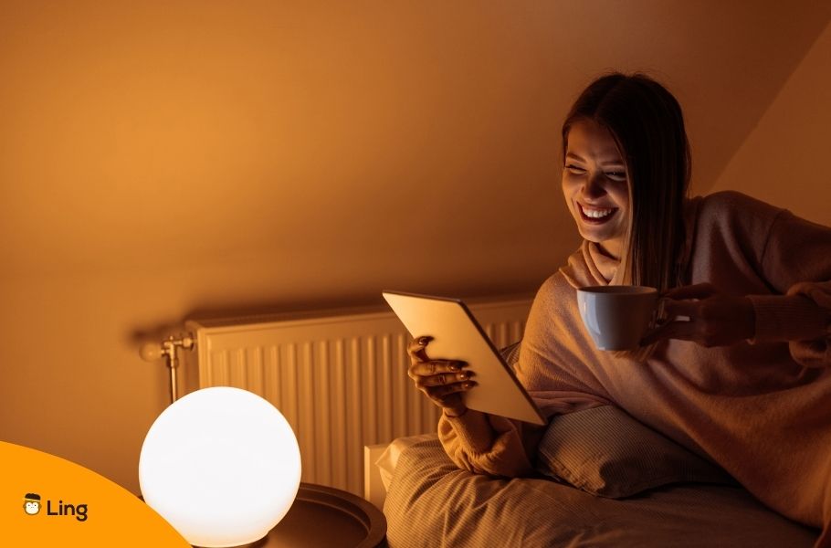 Smiling Woman Saying Good Night To Someone On A Videocall On A Tablet