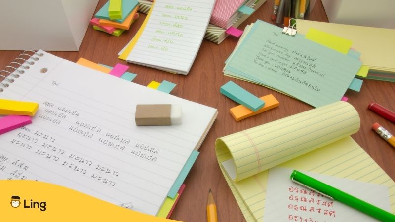 Thai notebooks and sticky notes on table