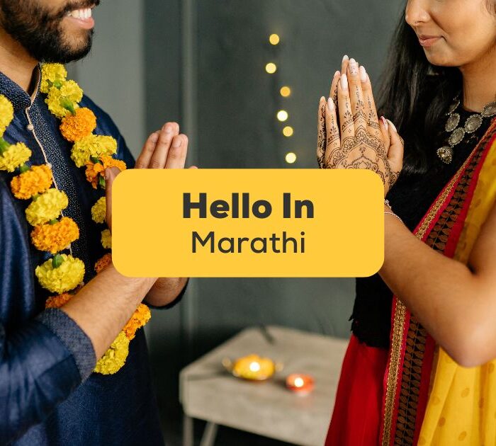 Indian man and woman saying Hello in Marathi with a namaste gesture