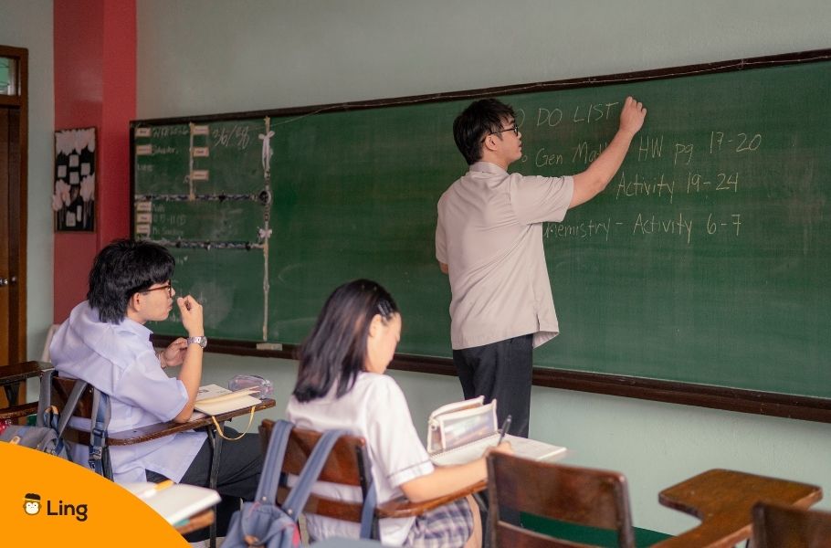 Two Students Learning From A Teacher In A Classroom